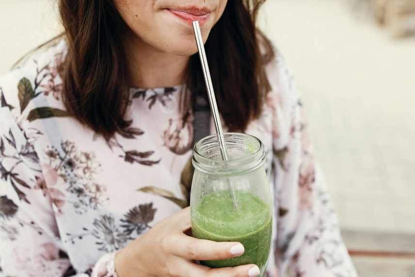Image of a woman drinking a Moringa smoothies