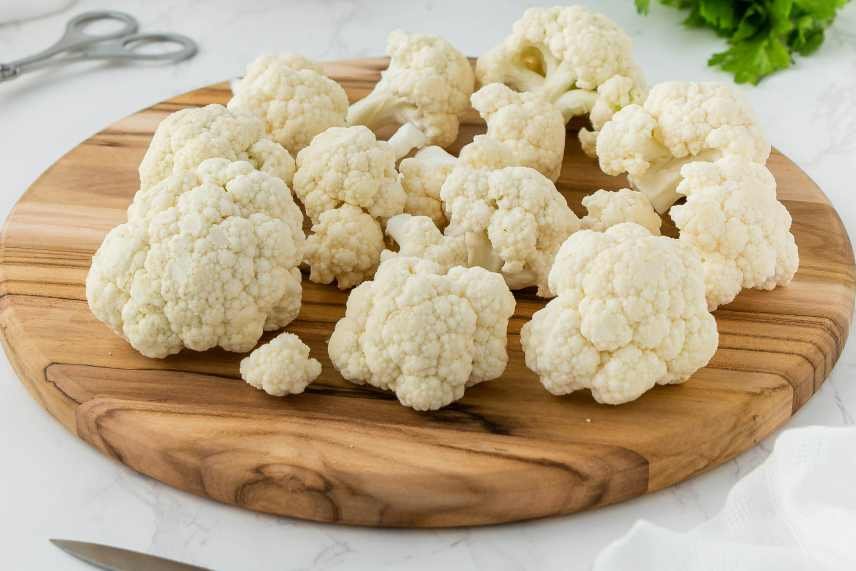 An image of cauliflower florets on a chopping board depicting the Tropical Cauliflower Smoothie Trend
