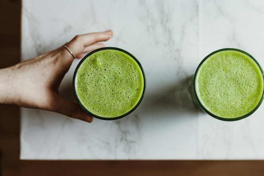 Two green smoothies on a table