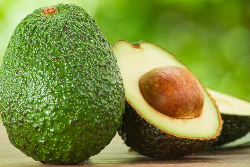 An image of one and a half avocados, being the key ingredient in a Creamy Avocado and Spinach Smoothie.