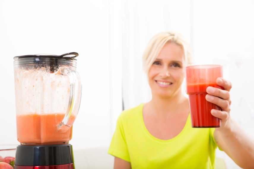 A woman enjoying a freshly made carrot smoothie for weight loss.