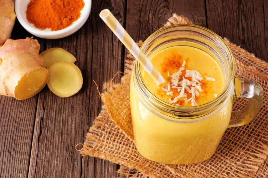 Pineapple, turmeric, ginger smoothie in a mason jar.